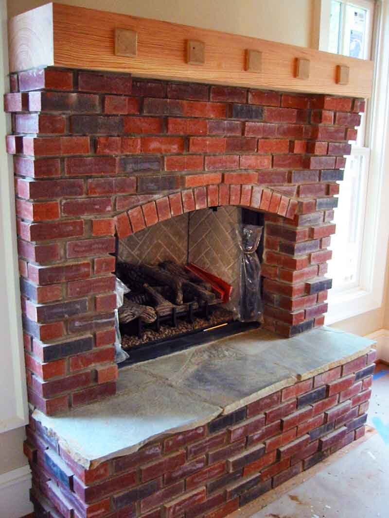 inside-red-brick-fireplace-wooden-mantle